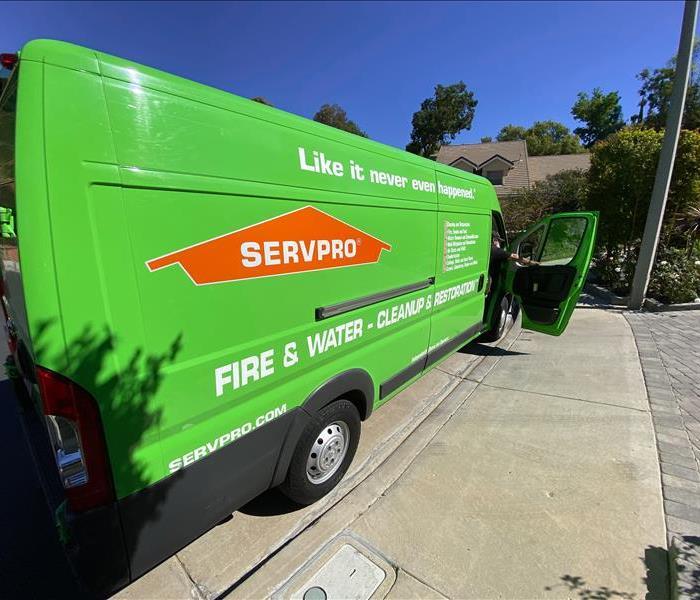 SERVPRO van arriving at property loss, parked at base of driveway